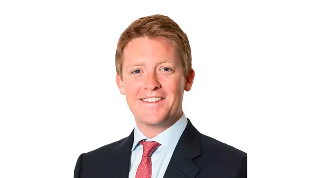 Archive studio portrait of Hugh Grosvenor in a suit and red tie.