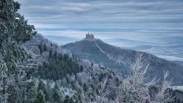 A snow-covered landscape with a distant castle
