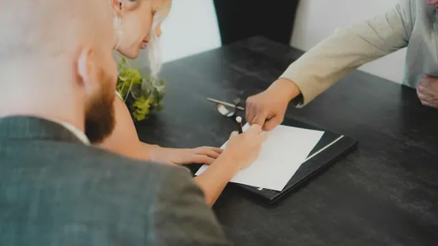 People reviewing paperwork; illustrative photograph.