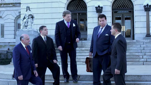 Archive law firm video still showing a group outside a building.