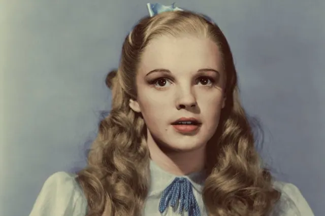 Archive publicity image of Judy Garland wearing Dorothy’s blue-and-white dress.