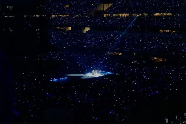An audience in a darkened concert venue in an archive photograph.