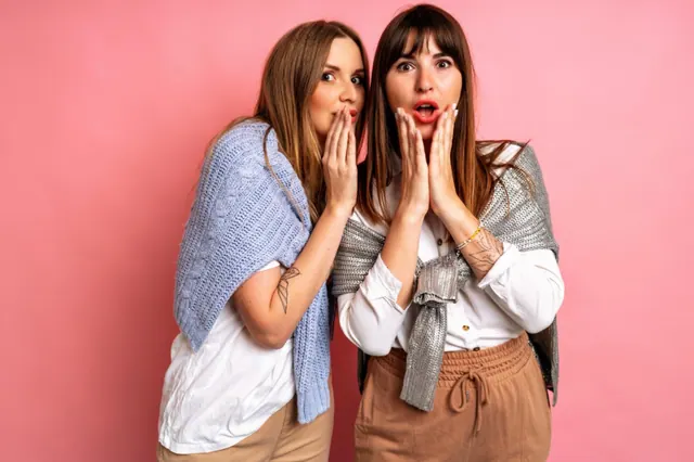 Stock photograph of two women making surprised expressions.