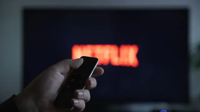 An out of focus TV displaying the Netflix logo