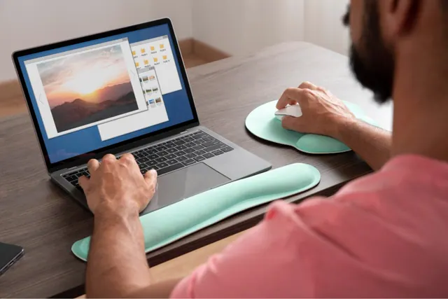 Stock photograph of a person editing an image on a laptop.