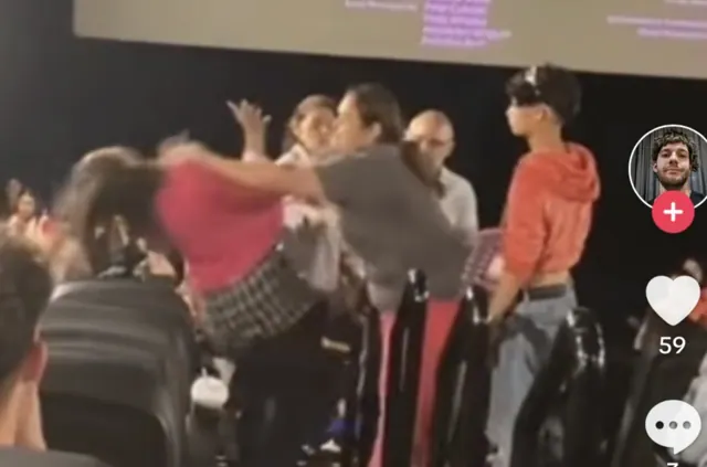 Archive video frame showing the reported cinema confrontation among the seats.