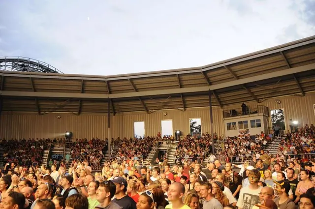 An audience seated in an indoor hall in an archive photograph.