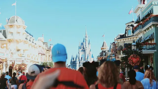 Visitors walking in a Disney theme park; illustrative photograph.