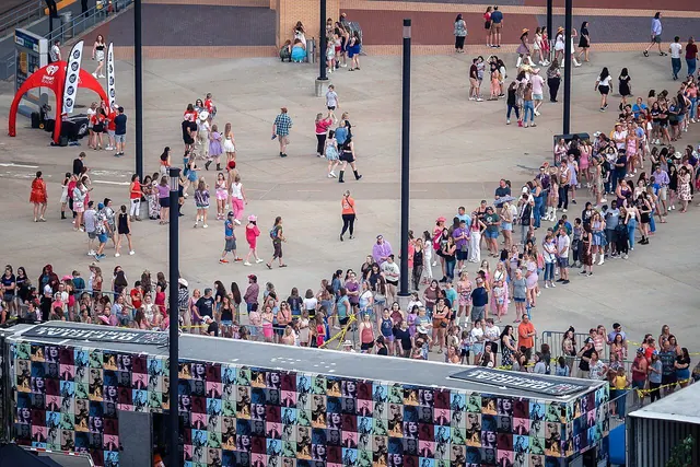 A line of people outside a venue in an archive photograph.