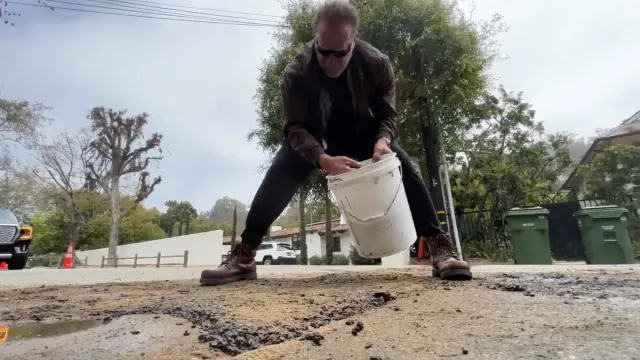 Illustration for “Watch Arnold Schwarzenegger Fill a Pothole — 'You Have to Do It Yourself'”