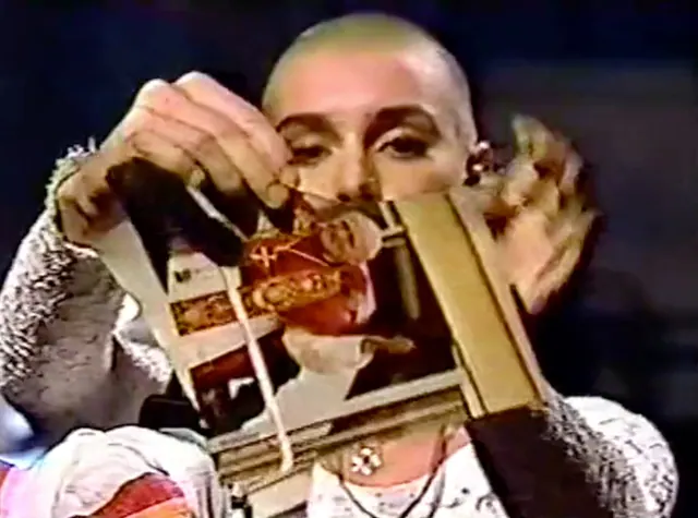 Sinéad O’Connor holding a torn photograph during her SNL performance