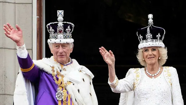 Archive photograph of Charles and Camilla wearing crowns and waving.