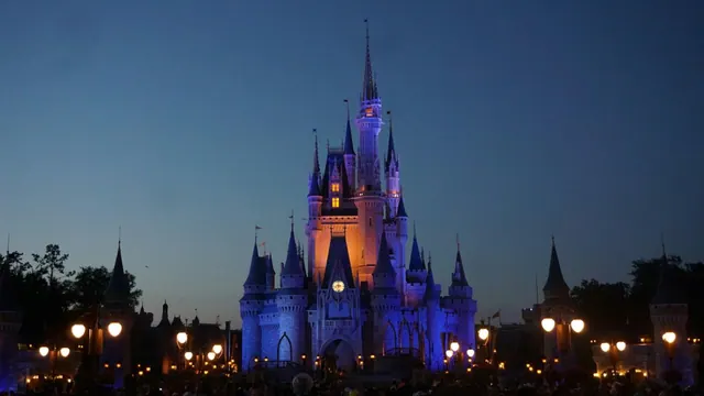 A Disney theme-park castle at night.