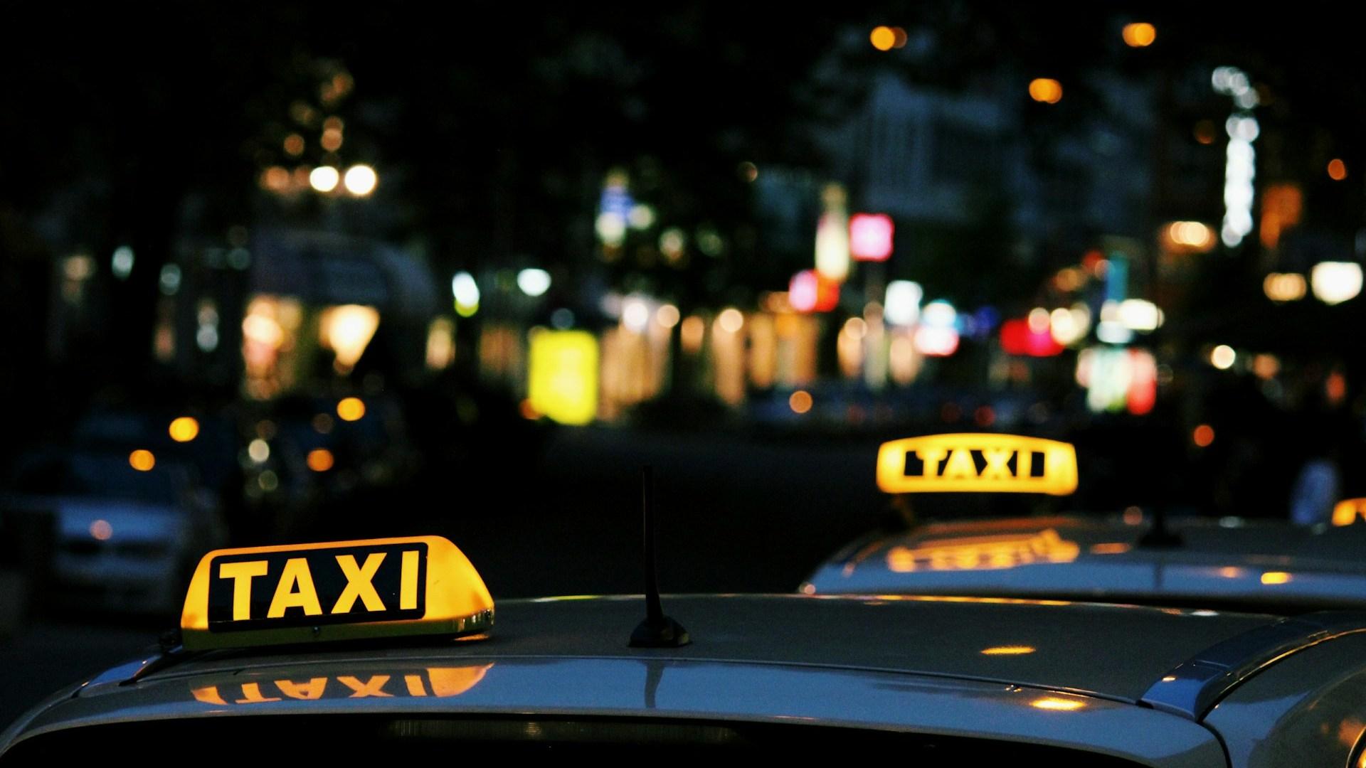 Taxi signs on cars at night