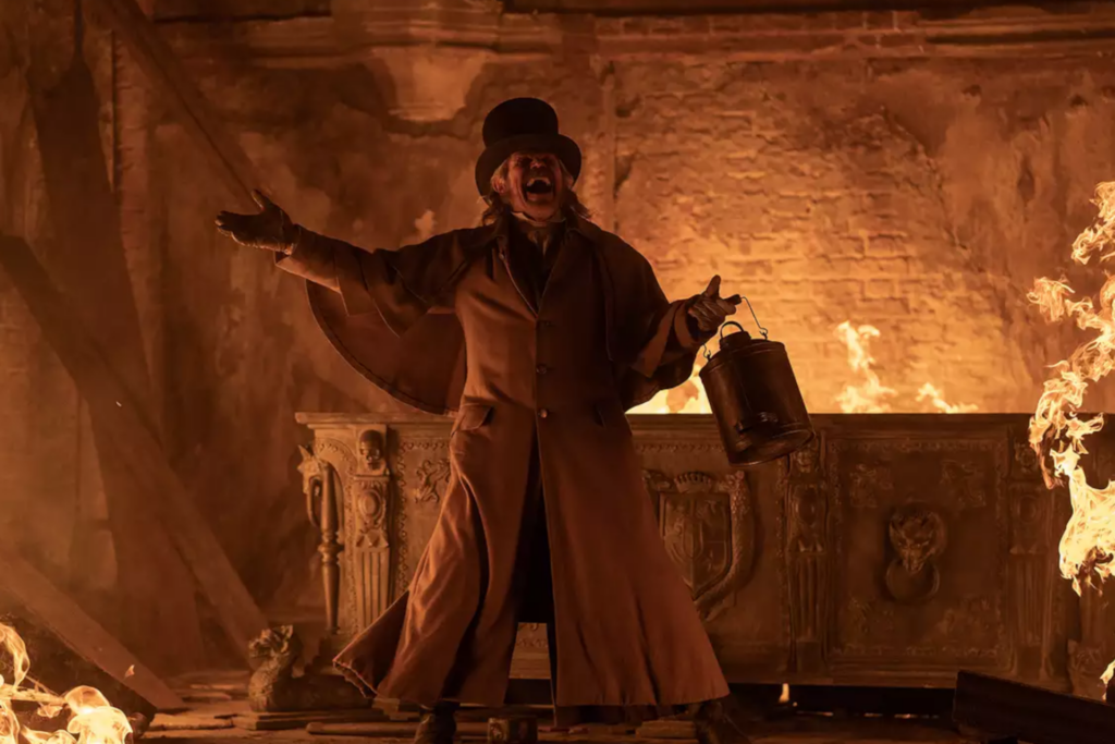 Willem Dafoe in a firelit scene from Nosferatu