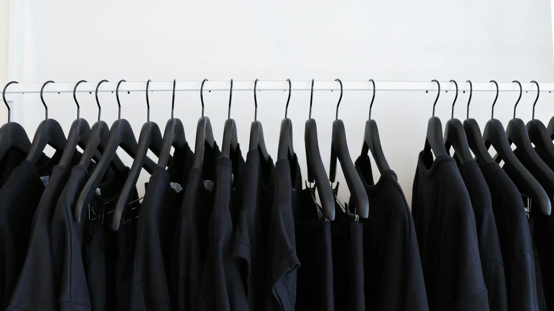 Dark clothes on hangers; illustrative photograph.