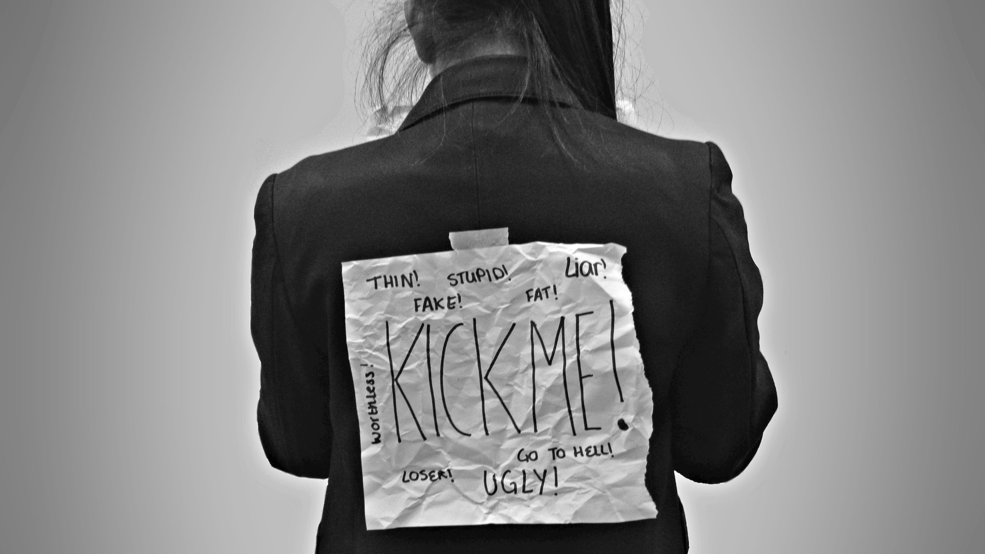 A person wearing a sign about bullying; illustrative photograph.