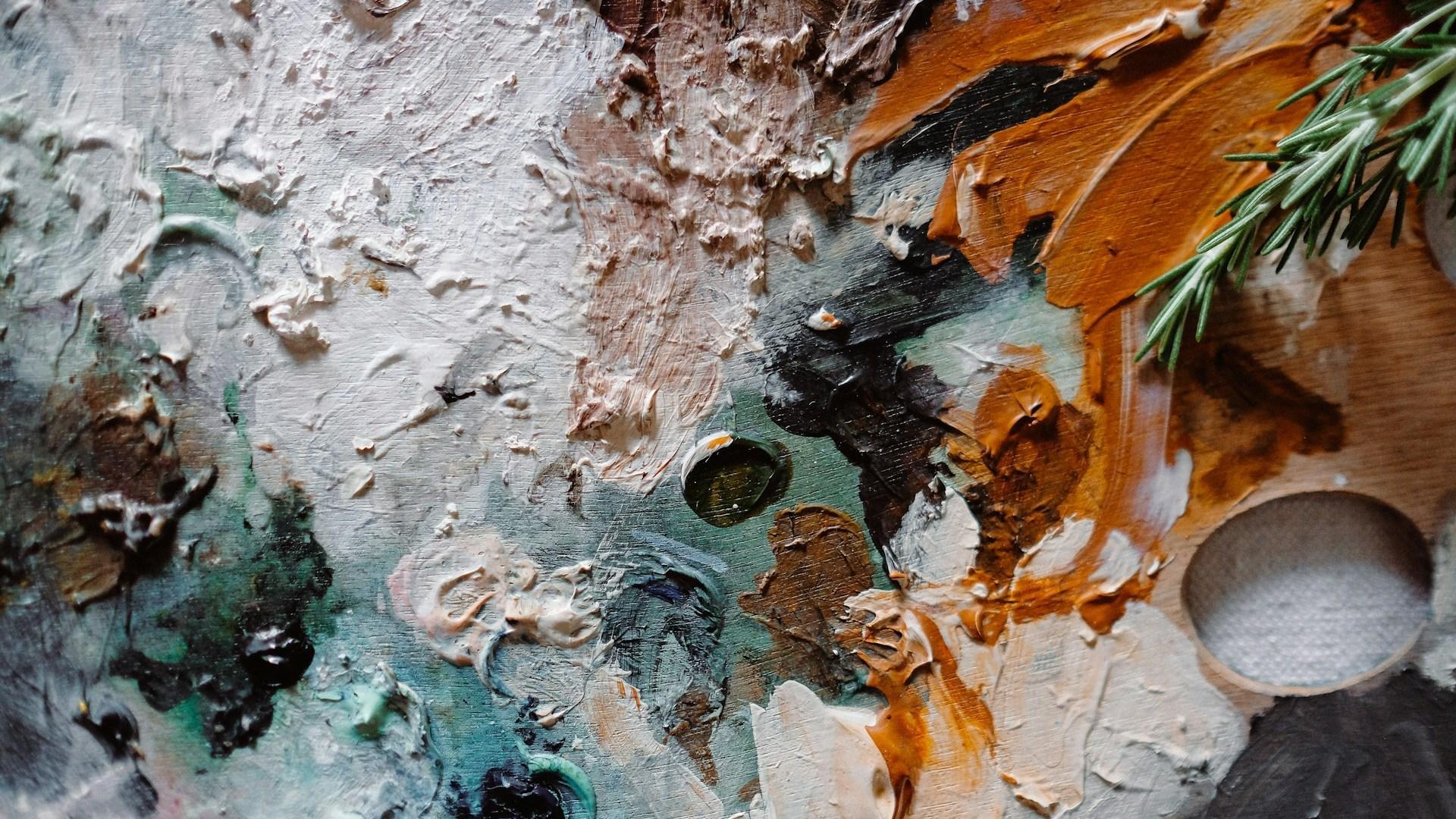 A close view of paint on an artist palette.