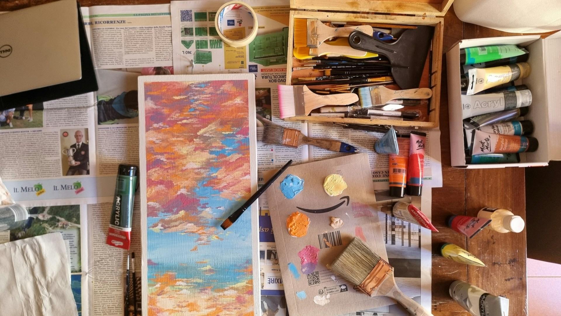 An artist work area with canvases and supplies.