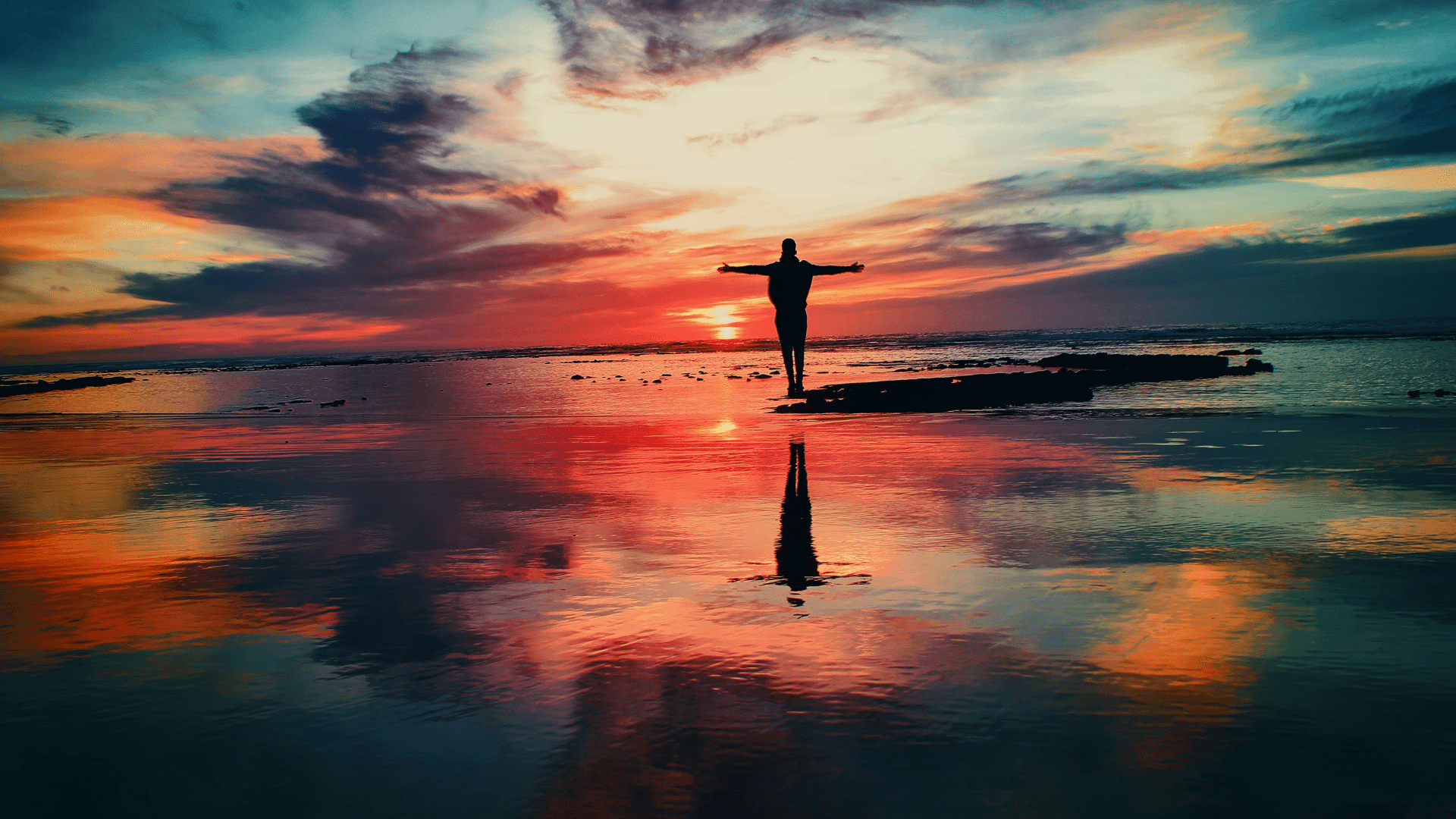 A person standing by water at sunset; illustrative photograph, not identified as Lisina.