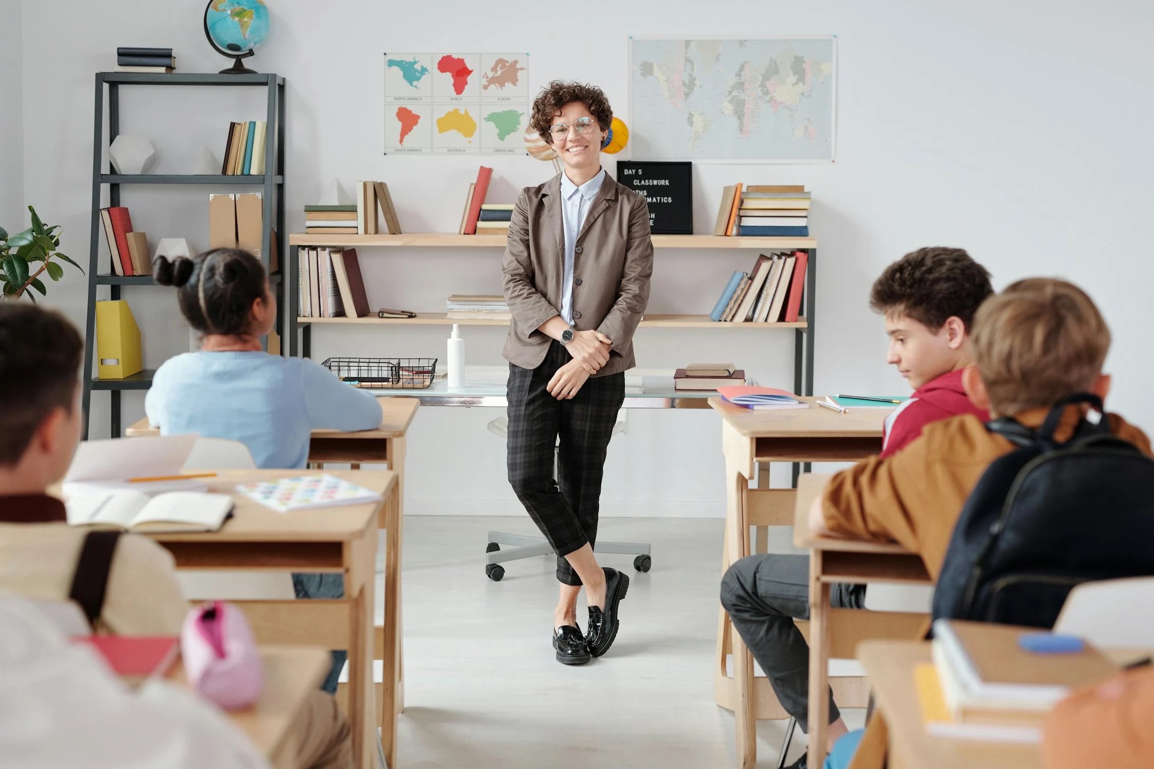 A teacher in a classroom; illustrative stock photograph.
