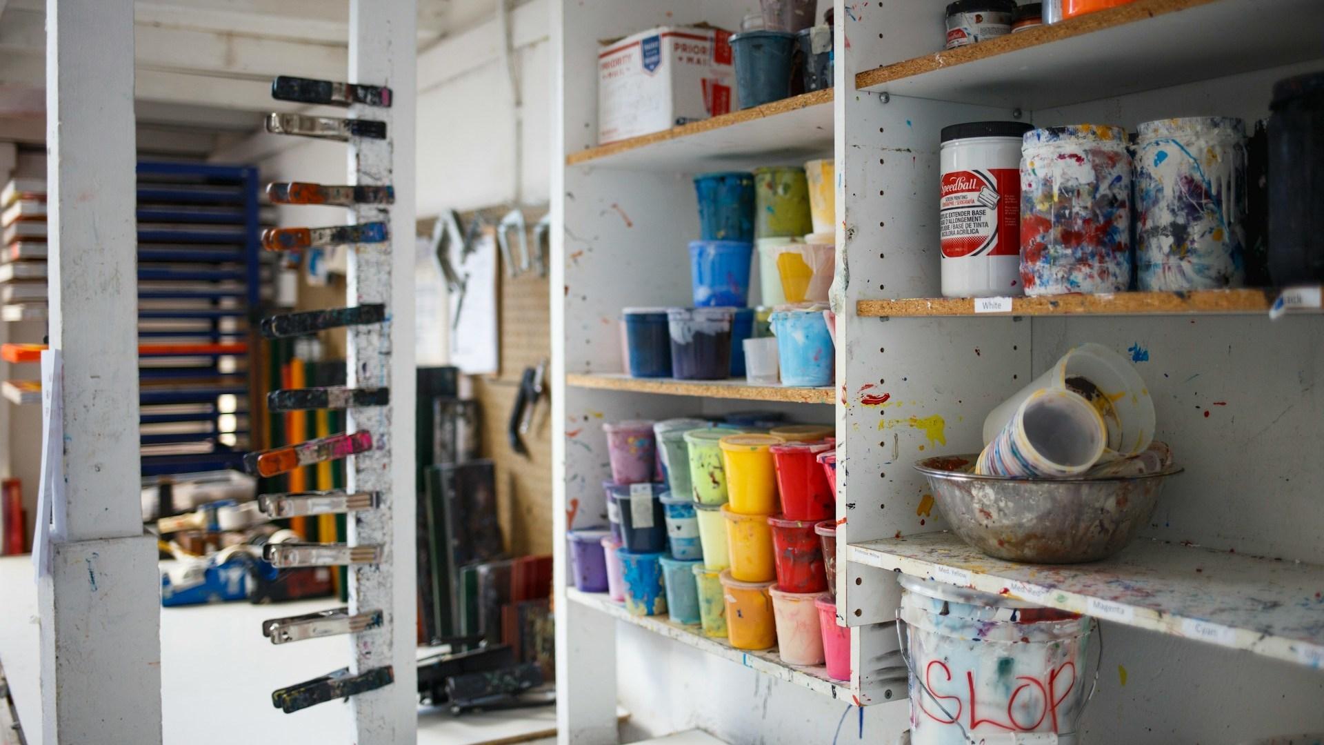 Shelves of materials in an art studio.