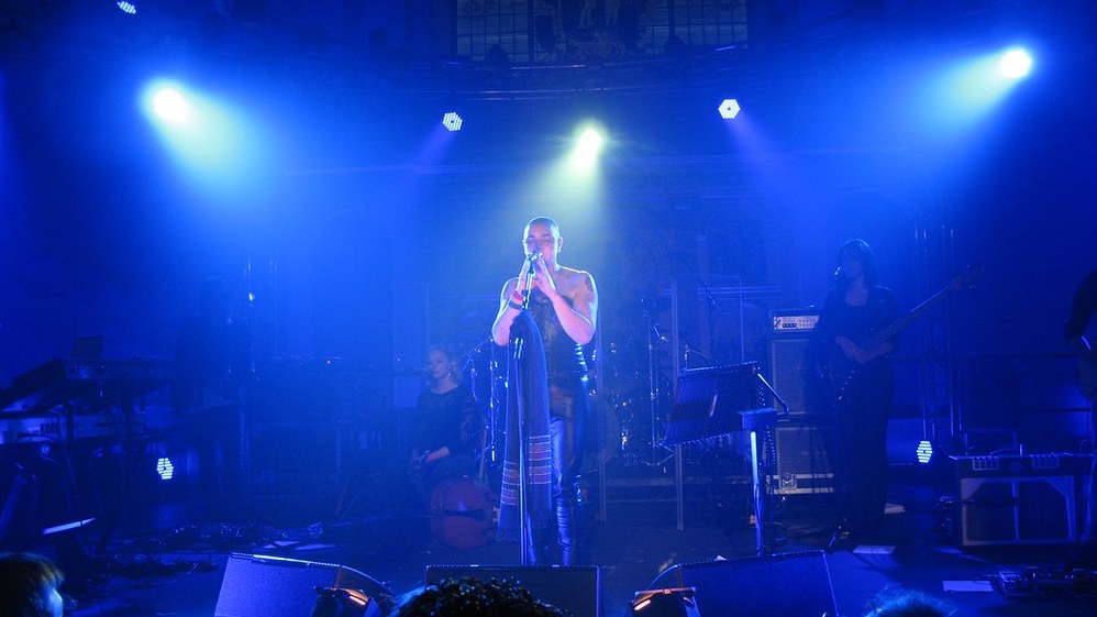 Sinéad O’Connor on a brightly lit stage