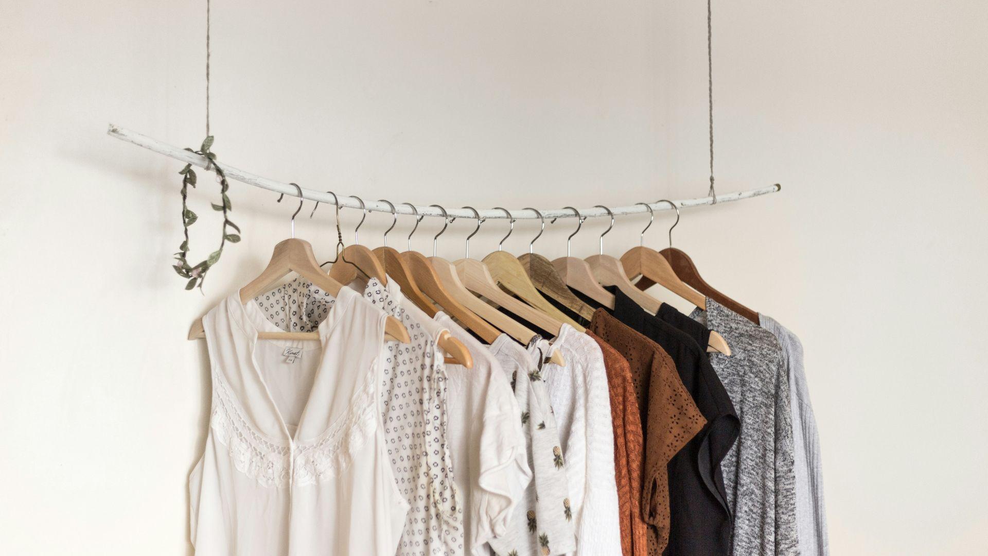 Clothes hanging on a rail; illustrative photograph.
