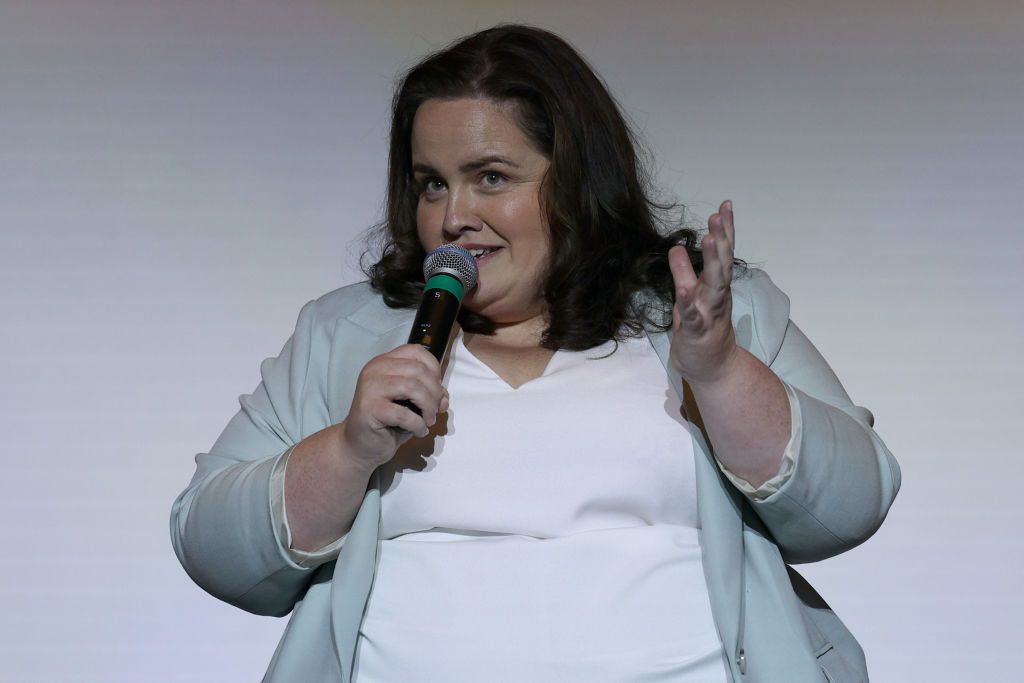 Jessica Gunning speaking into a microphone at an event.